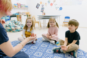 Photo of children playing with a ball with play therapist Photo by Ksenia Chernaya: https://www.pexels.com/photo/kids-at-the-daycare-8535592/