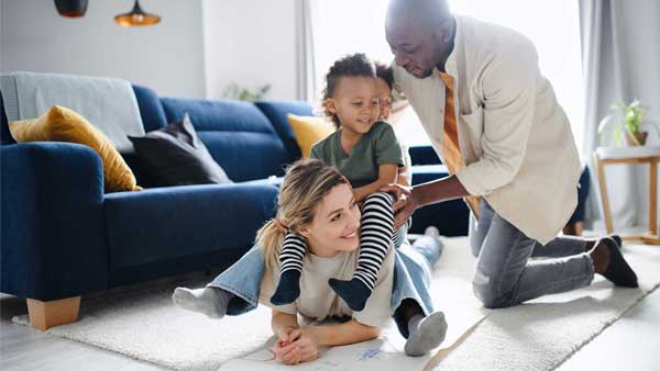 Multicultural family playing on the floor together